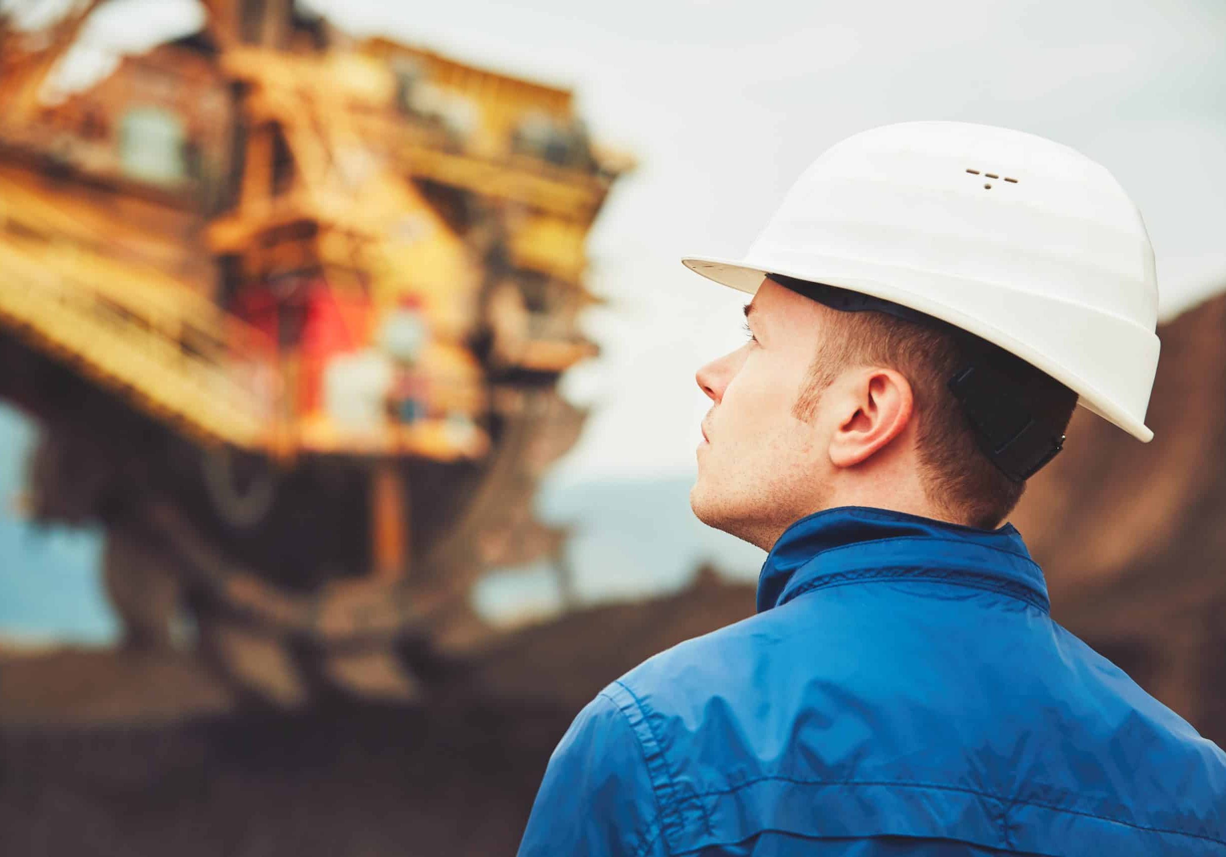 Coal mining in an open pit - Worker is looking on the huge excavator - industry in Czech Republic